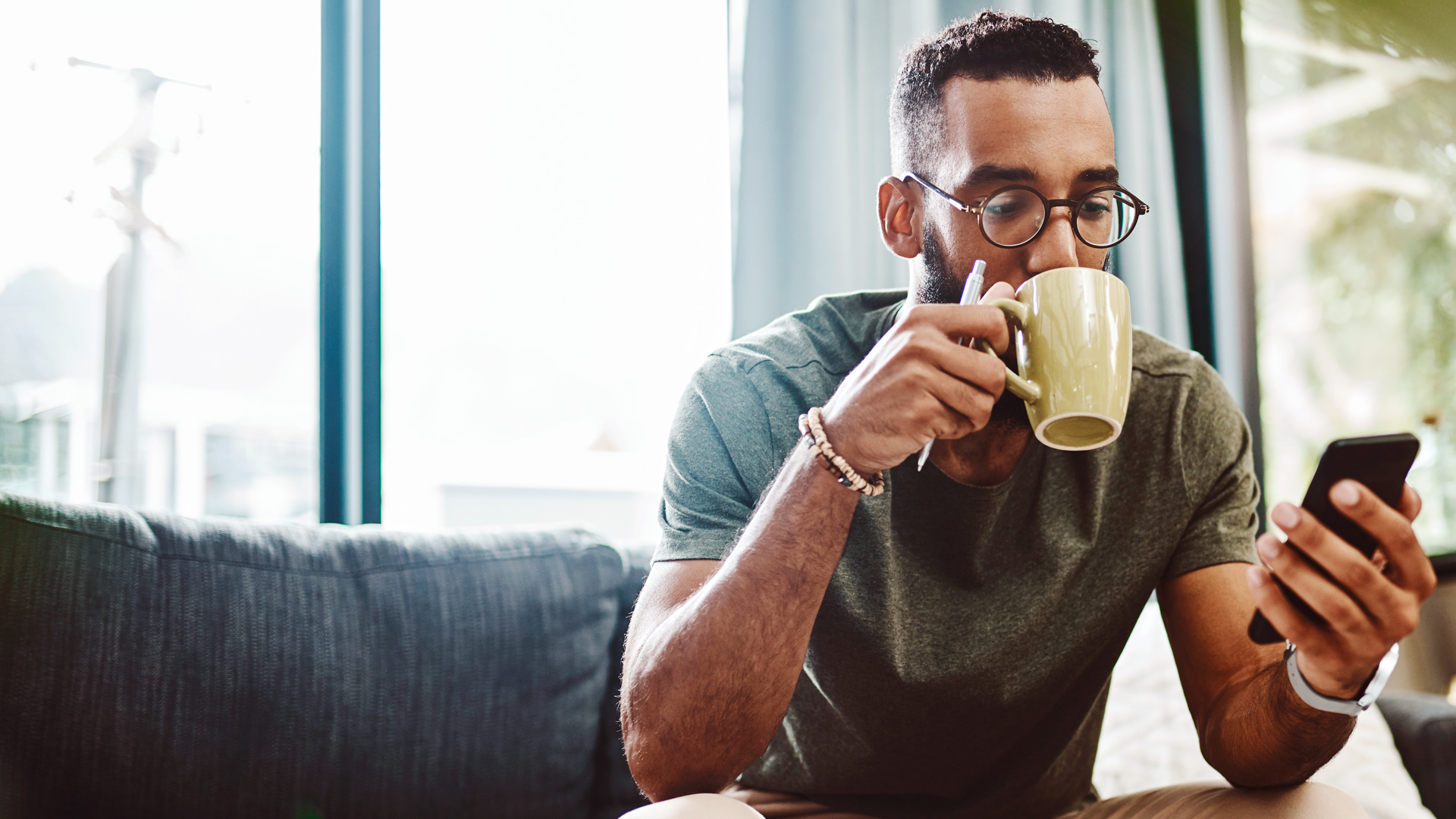 Photo of a man reading news on his phone