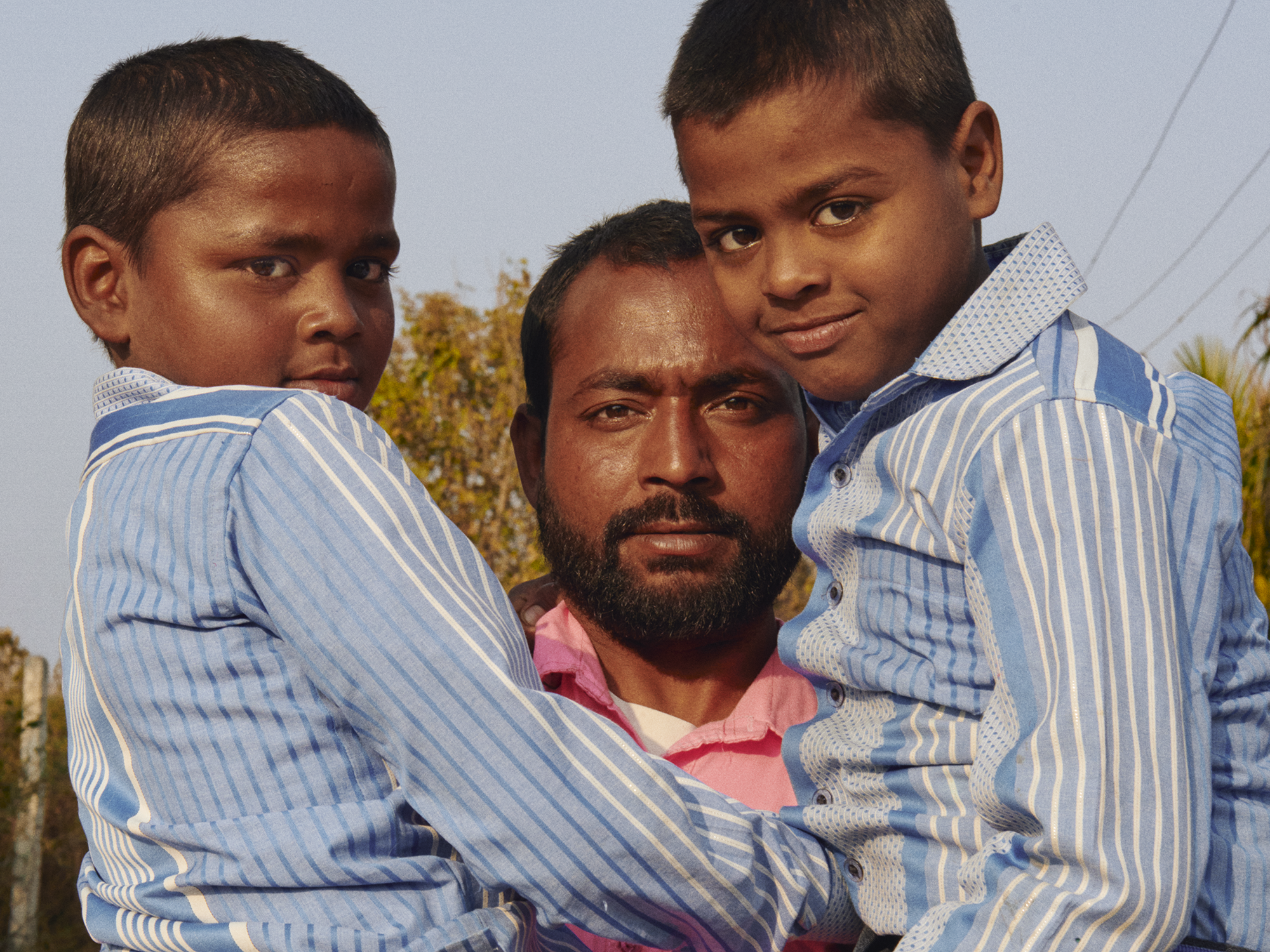 man holding his two sons