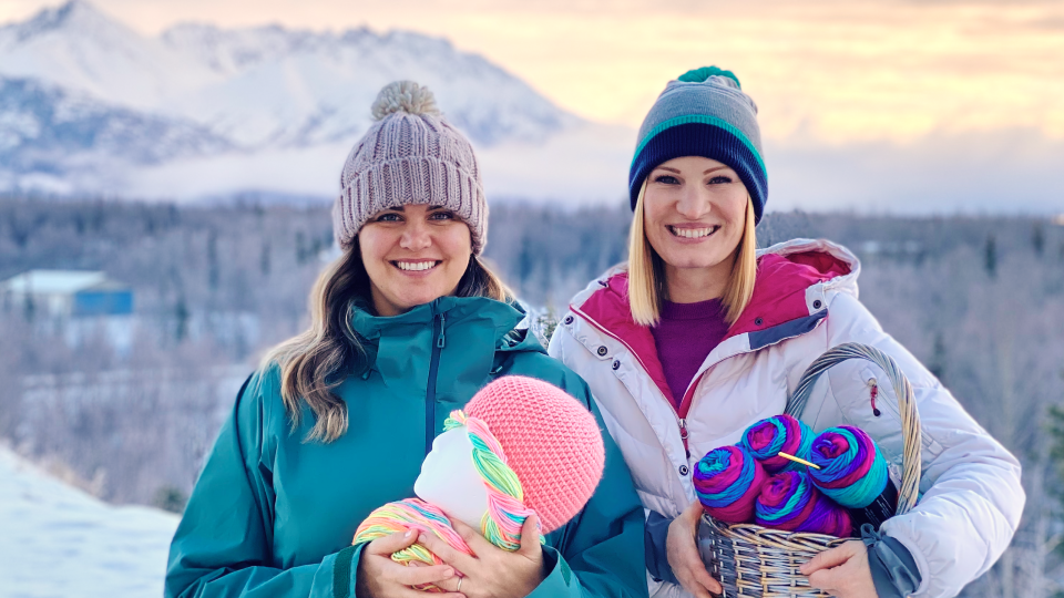 Photo of Holly Christensen and Bree Taylor posing with yarn and a wig