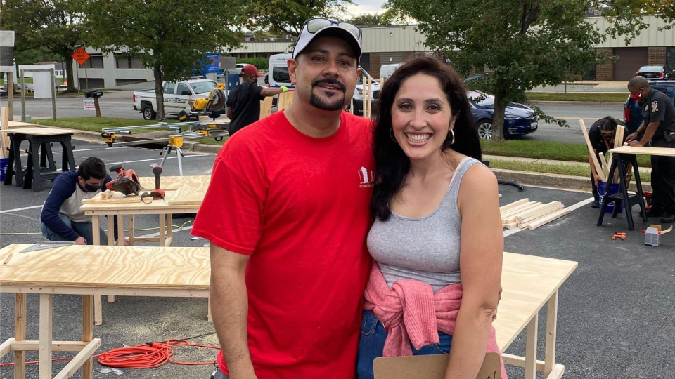 Photo of Jessica and Al Berrellez in front of desks