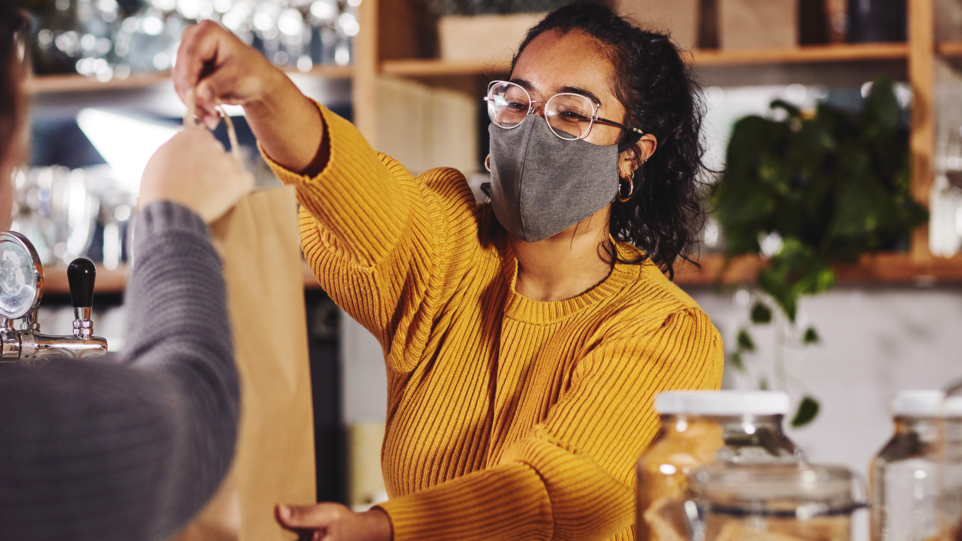 A barista completing a transaction with a customer