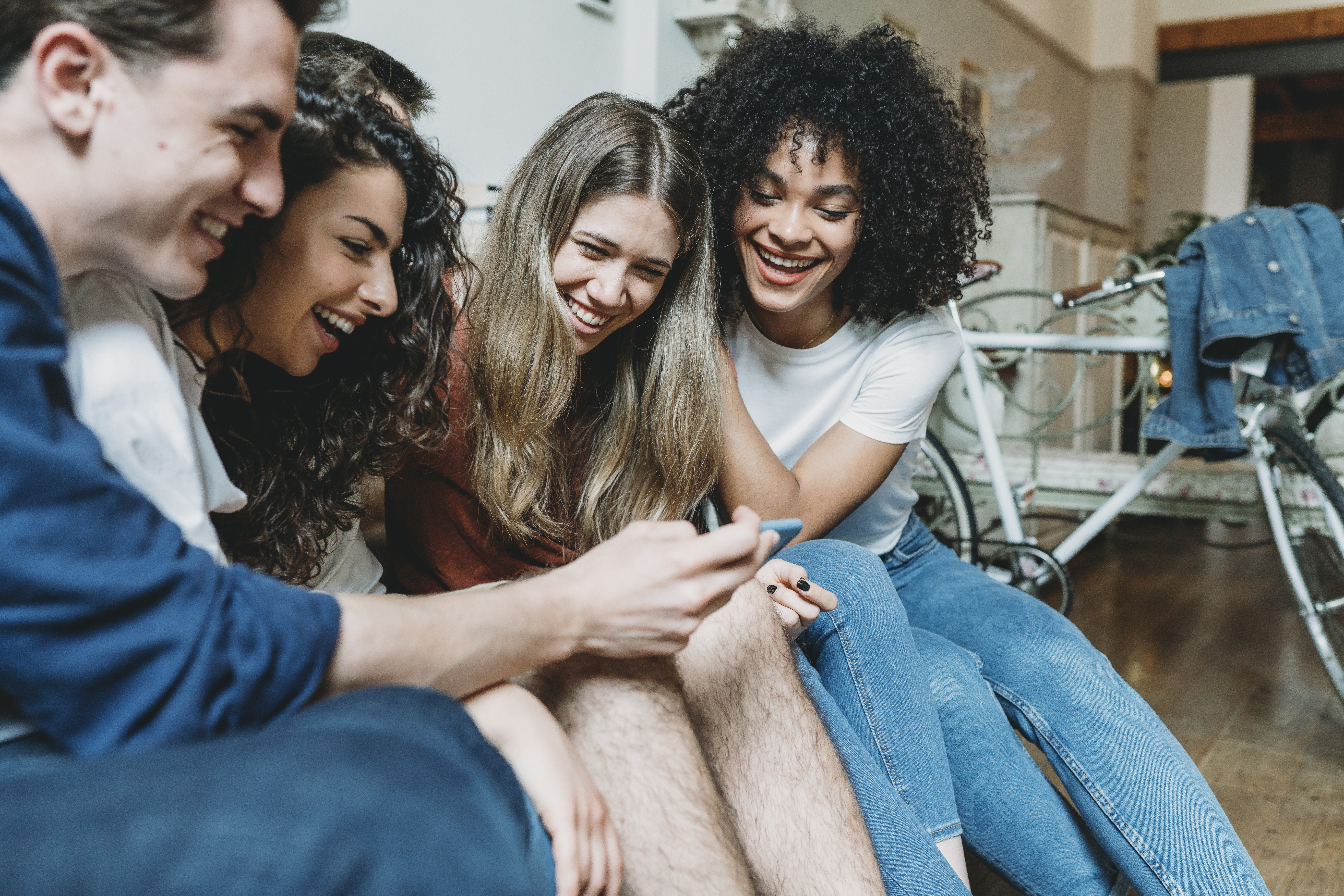 Friends looking at a mobile phone together
