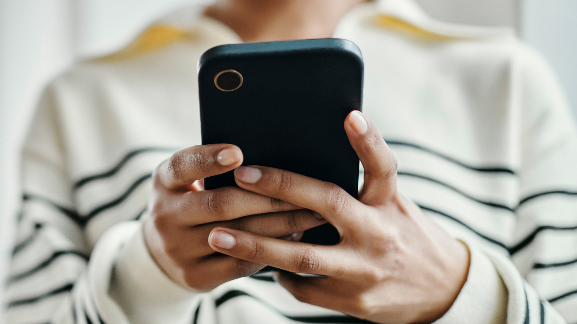 Photo of a woman holding a phone